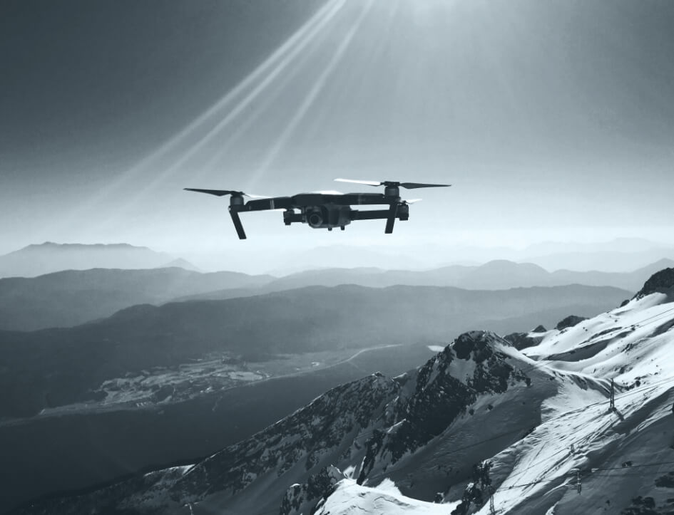 Camera drone flying above a mountain landscape