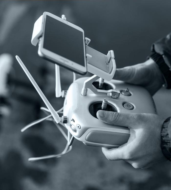 Drone pilot using a remote controller for aerial photography